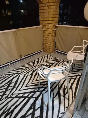 a pair of chairs and a rug on a patio at Mlangeni's Rest in Centurion