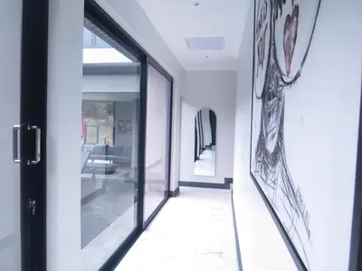 a hallway of a house with glass doors at Thaba Bosiu Villa in Naboomspruit