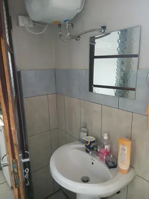 a bathroom with a sink and a mirror at Thonta house in Pretoria