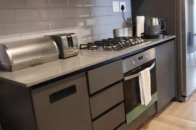 a kitchen with a stove and a counter top at Urban Oasis Retreat in Midrand in Midrand