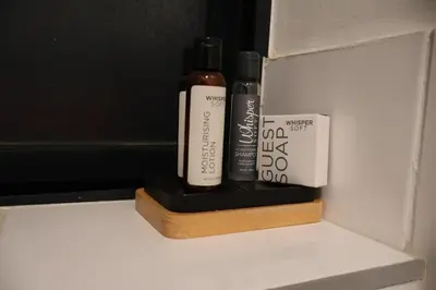 two bottles of hair products sitting on a shelf at Urban Oasis Retreat in Midrand in Midrand