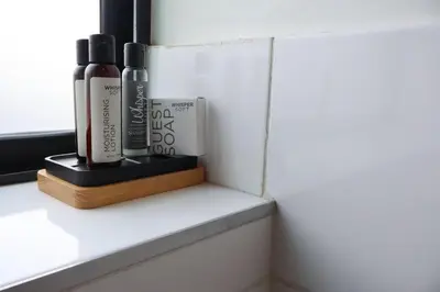 a shelf with two shampoo bottles on a window sill at Urban Oasis Retreat in Midrand in Midrand