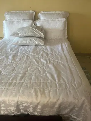 an unmade bed with white sheets and pillows at Vhonani 9 in Polokwane