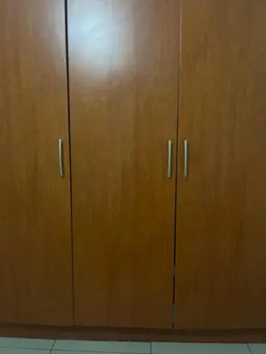 a pair of wooden cabinets with metal handles at Vhonani 9 in Polokwane