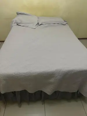 a bed with white sheets and pillows on it at Vhonani 9 in Polokwane