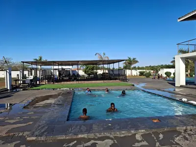 a group of people swimming in a swimming pool at The Private Location in Thohoyandou