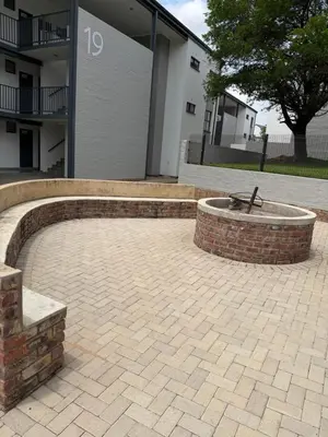 a brick patio with a fountain in front of a building at Elevare suites in Nelspruit