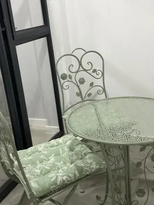 a table and a chair next to a mirror at Elevare suites in Nelspruit