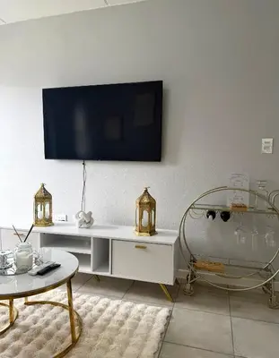a living room with a tv on the wall at Elevare suites in Nelspruit