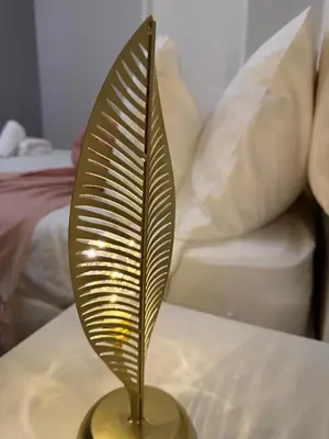 a metal sculpture of a leaf on a table at Elevare suites in Nelspruit