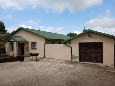 a house with a garage and a driveway at 41 on Clarendon in Graskop