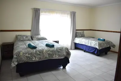 a bedroom with two beds and a window at 41 on Clarendon in Graskop