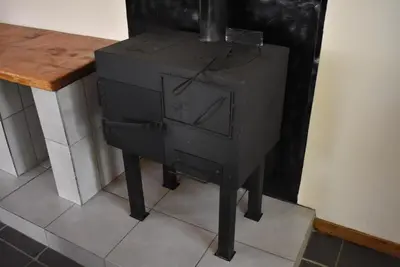 a wood stove sitting next to a counter in a room at 41 on Clarendon in Graskop
