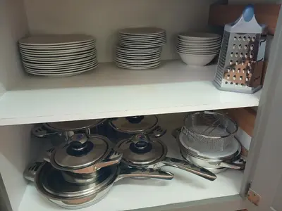 a shelf with plates and utensils in a kitchen at 41 on Clarendon in Graskop