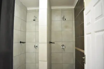 a bathroom with a shower with a glass door at 41 on Clarendon in Graskop