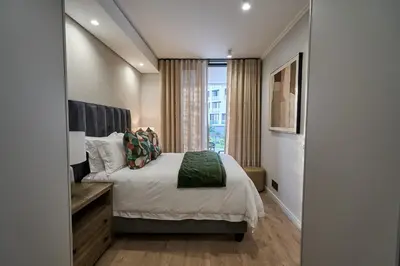 a bedroom with a large bed and a window at Hidden Diamond at Ellipse Waterfall in Midrand