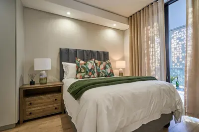 a bedroom with a large bed and a window at Hidden Diamond at Ellipse Waterfall in Midrand