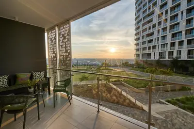 a balcony with a view of a building at Hidden Diamond at Ellipse Waterfall in Midrand