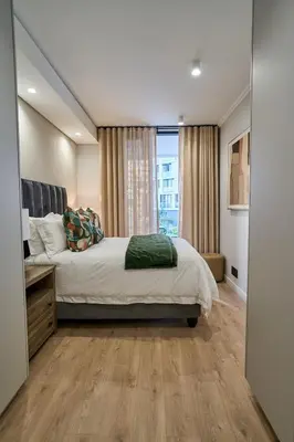 a bedroom with a large bed and a window at Hidden Diamond at Ellipse Waterfall in Midrand
