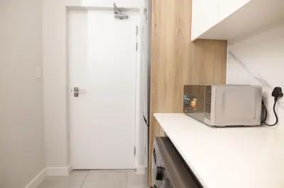 a microwave sitting on top of a counter in a kitchen at Waterfall Munyaka Estate in Midrand