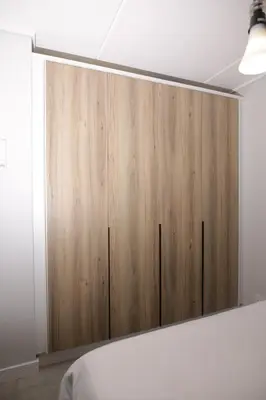 a large wooden cabinet in a room with a bed at Waterfall Munyaka Estate in Midrand