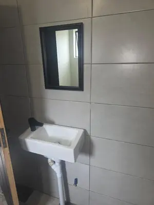 a bathroom with a sink and a mirror on the wall at The Good Samaritan 1 in Witbank