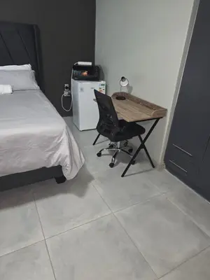 a bedroom with a desk and a bed and a chair at The Good Samaritan 1 in Witbank