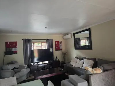 a living room with two couches and a flat screen tv at Entire Home - Relax - Work - Entertain - Private in Centurion