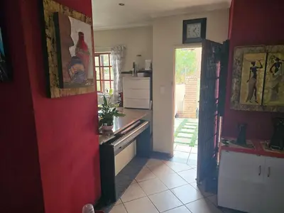 a kitchen with red walls and a red wall at Entire Home - Relax - Work - Entertain - Private in Centurion