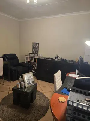 a living room with a desk with a laptop on a table at Entire Home - Relax - Work - Entertain - Private in Centurion