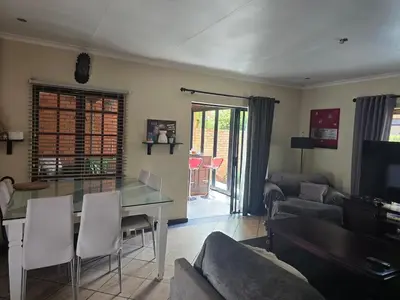 a living room with a couch and a table at Entire Home - Relax - Work - Entertain - Private in Centurion