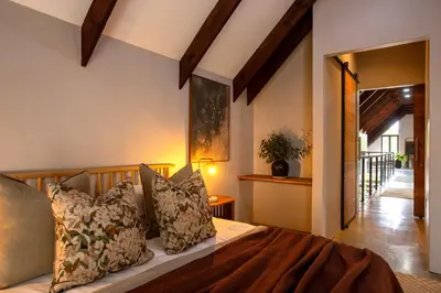 a bedroom with a bed with pillows at House Nyala in Lydenburg