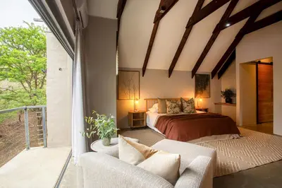 a bedroom with a bed and a couch at House Nyala in Lydenburg