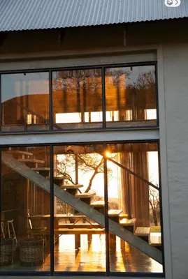 a reflection of a table in the windows of a building at House Nyala in Lydenburg