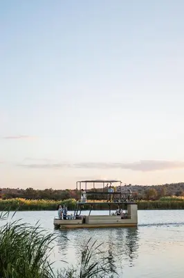 a boat on the water with people on it at Kambaku II Boat Safaris & Lodge in Phalaborwa