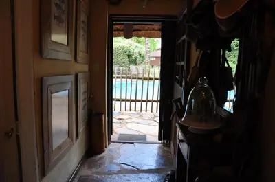 a hallway with a door leading to a pool at Gunyatoo Trout Trout Farm & Guest Lodge in Sabie
