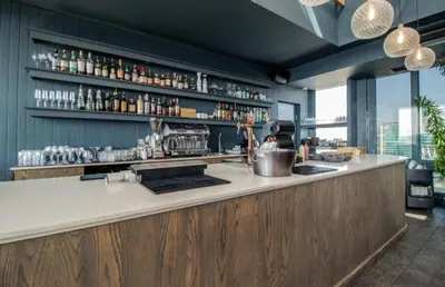 a kitchen with a bar with a counter top at Menlyn Maine Trilogy Apartment 914A in Pretoria