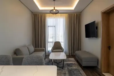 a living room with a couch and a chair at Radisson Hotel & Convention Center Steve Tshwete Middelburg in Middelburg