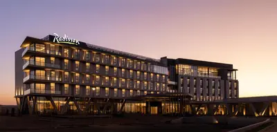 a building with a sign on top of it at Radisson Hotel & Convention Center Steve Tshwete Middelburg in Middelburg