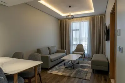a living room with a couch and a table and chairs at Radisson Hotel & Convention Center Steve Tshwete Middelburg in Middelburg