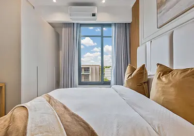 a bedroom with a bed with a large window at MNM Luxury Suit 424 in Pretoria