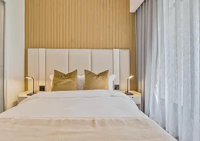 a bedroom with a large white bed with two lamps at MNM Luxury Suit 424 in Pretoria