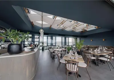 a restaurant with wooden tables and chairs and windows at MNM Luxury Suit 424 in Pretoria