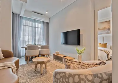 a living room with a couch and a bed at MNM Luxury Suit 424 in Pretoria