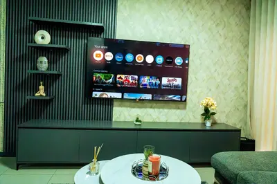 a living room with a tv and a table at Modern 3-Bedroom Retreat Fully Equipped Comfort in Midrand