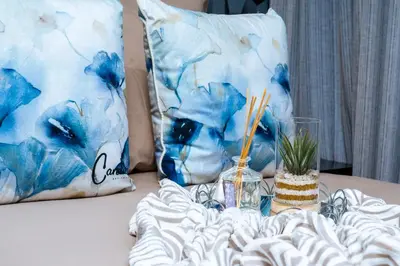 a bed with blue pillows and a table with chopsticks at Modern 3-Bedroom Retreat Fully Equipped Comfort in Midrand