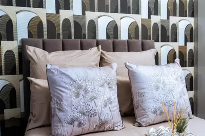 a group of pillows on a couch with a wall at Modern 3-Bedroom Retreat Fully Equipped Comfort in Midrand