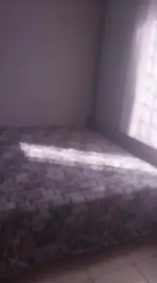 a bed in a room with a window at Sanctuary in Mahube Valley in Pretoria