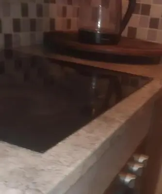 a glass counter top with a coffee pot on top at Sanctuary in Mahube Valley in Pretoria