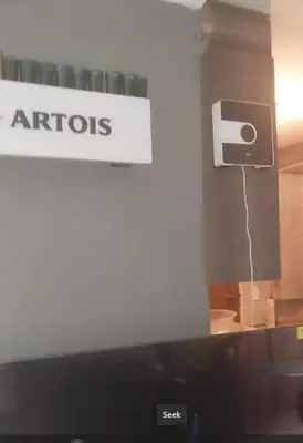 a monitor with aadobeadobeadobe sign on the side of a room at Sanctuary in Mahube Valley in Pretoria